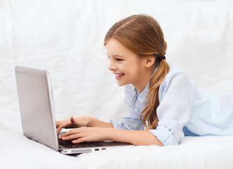 Poster - smiling girl with laptop computer at home