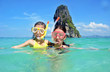 © Iuliia Sokolovska - Happy mother and kid snorkeling in tropical sea, family vacation