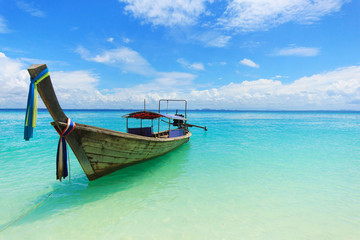 Wall Mural - Traditional long tail boat on a beach in Thailand