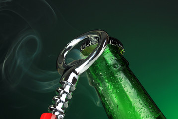 Top of open wet beer bottle on dark background