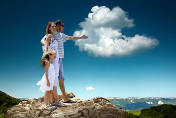 Family stay on the top of mountain, looking on the beautiful vie