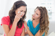 © lightwavemedia - Woman consoling a crying female friend at home