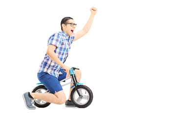 Poster - Excited guy riding a small bicycle and gesturing happiness