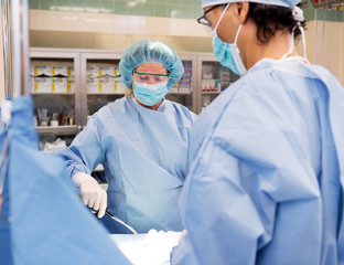 Wall Mural - Multiethnic Surgeons Operating on Patient