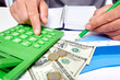 © grinny - Hands of businessman with calculator.