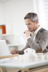 Wall Mural - architect working at his laptop on the office