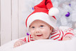 © golovianko - Smiling baby boy under the decorated Christmas tree