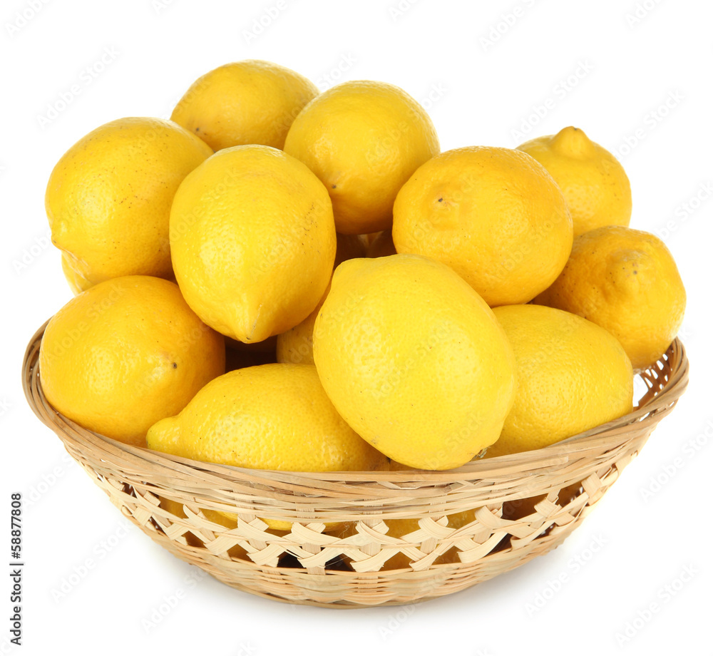 Ripe lemons in wicker basket isolated on white