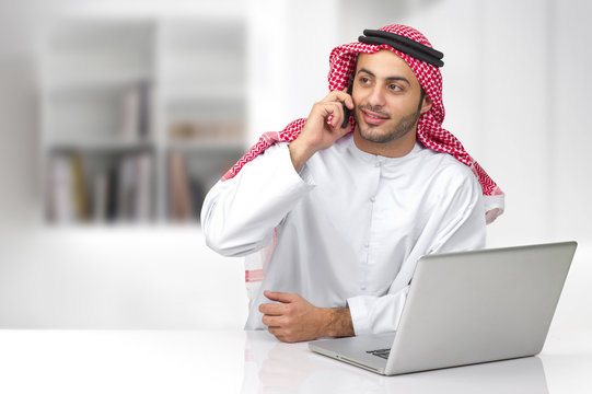 Arabian business man talking on phone in his office
