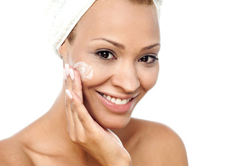 Pretty woman applying face cream