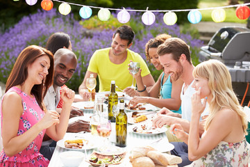 Group Of Friends Having Outdoor Barbeque At Home