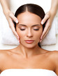 © puhhha - Face Massage. Close-up of a Young Woman Getting Spa Treatment.