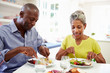 © Monkey Business - Mature African American Couple Eating Meal At Home