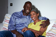 © Monkey Business - Mature African American Couple On Sofa Watching TV Together