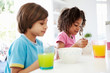 © Monkey Business - Two Children Having Breakfast In Kitchen Together
