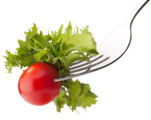 Fresh salad and cherry tomato on fork isolated on white backgrou