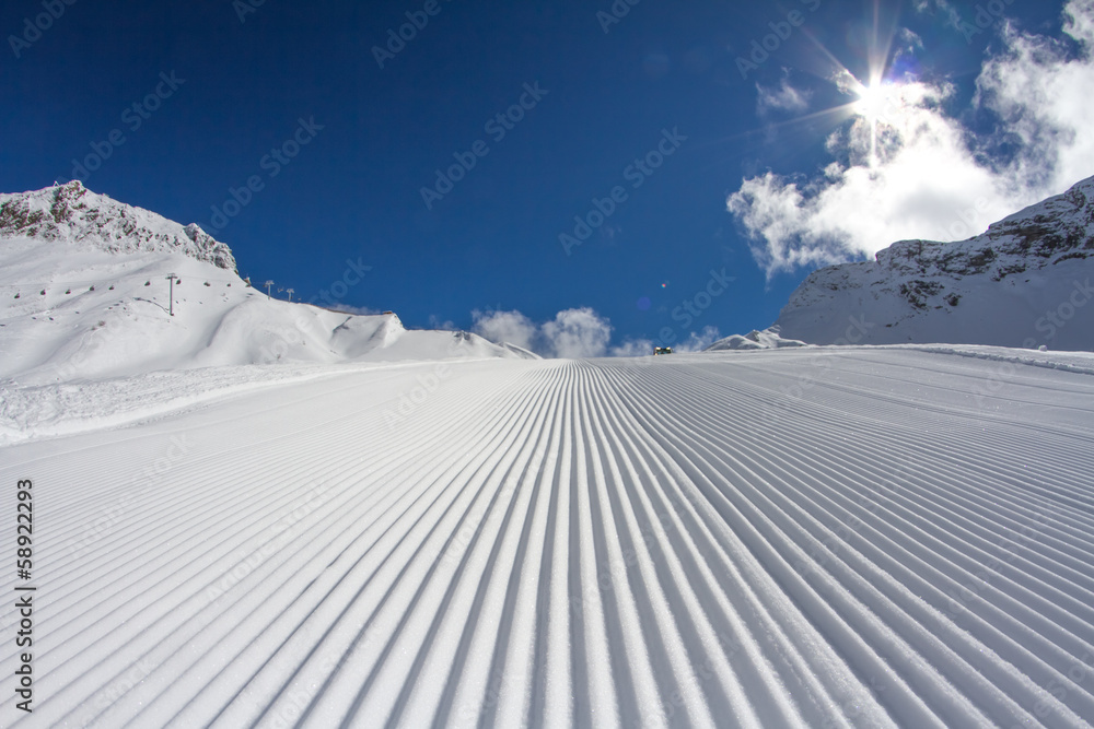 Fresh snow groomer tracks on a ski piste - obrazy, fototapety, plakaty 