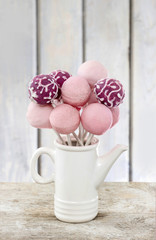 Poster - Pink cake pops on wooden table. Copy space