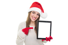 Beautiful Young Woman With Santa Hat Pointing At Tablet Screen