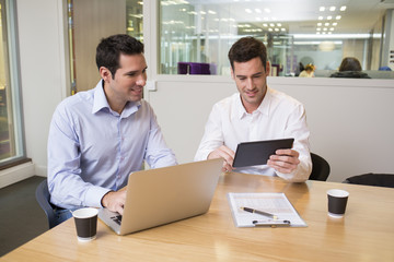 Two casual businessmen working together in modern office