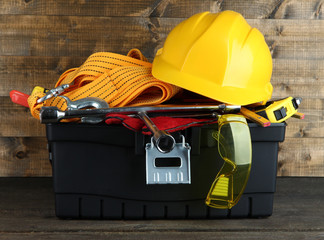 Wall Mural - Black toolbox with tools on wooden background