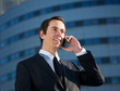 © mimagephotos - Young business man calling by mobile phone outdoors