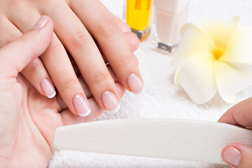 Wall Mural - Woman in a nail salon receiving manicure