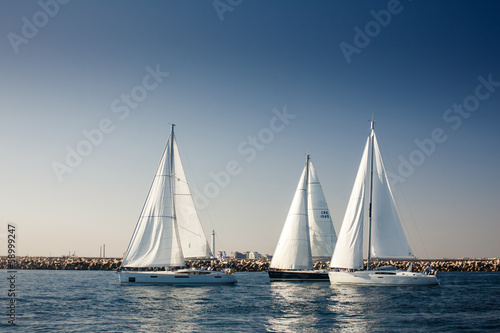 Fototapeta na wymiar Sailing ship yachts with white sails