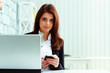 © Drobot Dean - Young serious businesswoman holding smartphone