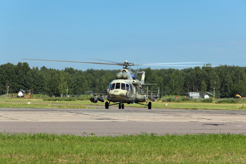 Wall Mural - The military helicopter at the airfield preparing for take-off