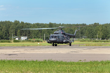 Wall Mural - The military helicopter at the airfield preparing for take-off