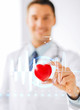 © Syda Productions - male doctor with heart and cardiogram