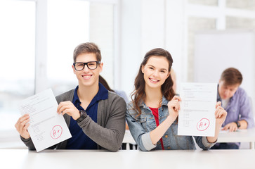 Canvas Print - two teenagers holding test or exam with grade A