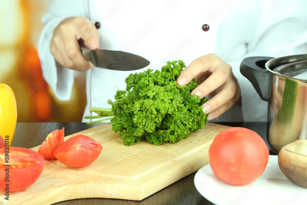 Cook hands cutting parsley