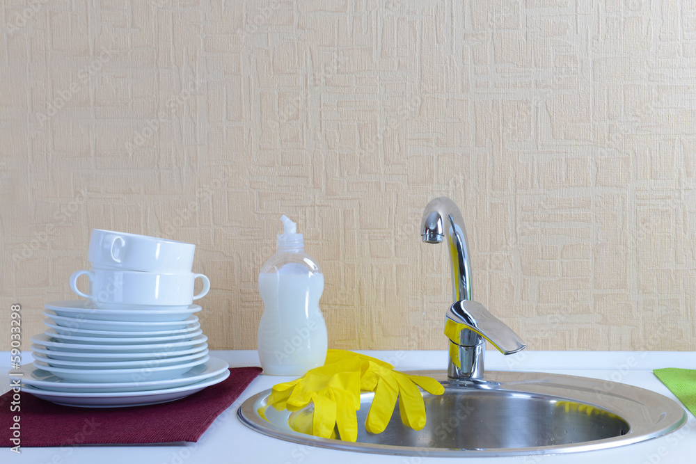 Dishes drying near  metal sink