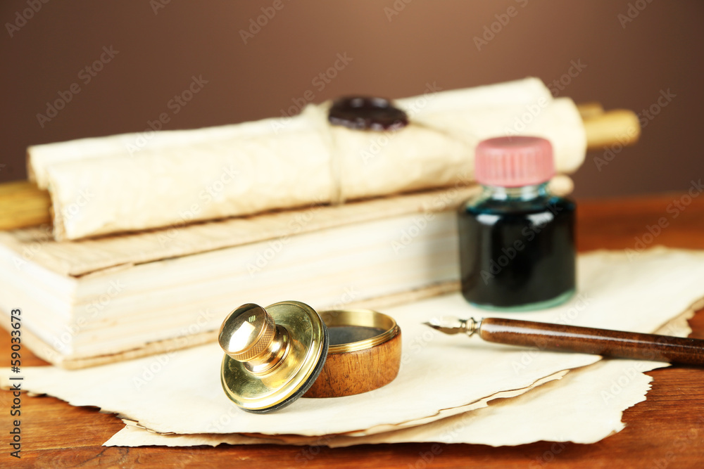 Wooden stamp, books and old papers on wooden table