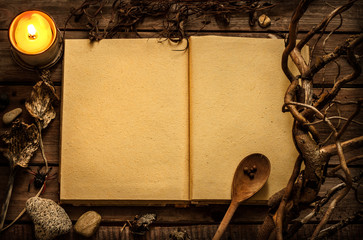 witchcraft or magic recipes book with alchemy ingredients around