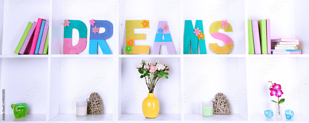 White shelves decorated with handmade knit word