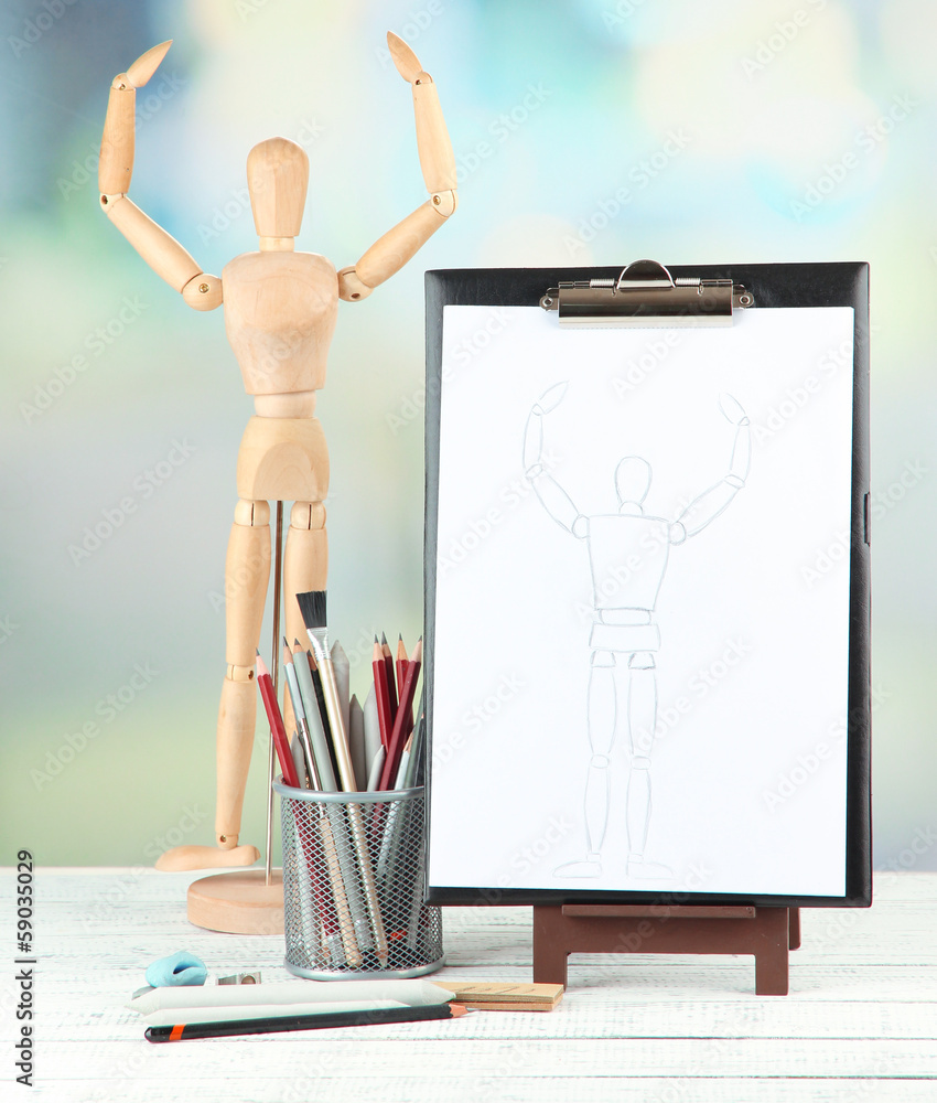 Sketch with professional art materials, on wooden table