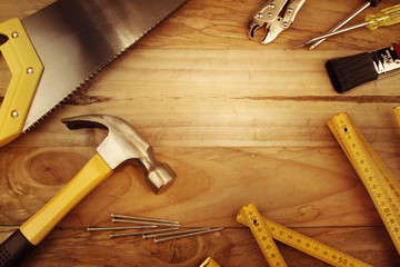 Poster - Assorted carpentry work tools on wooden background. Copy space