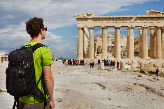 tourist looking at parthenon, acropolis ruin, athens, greece