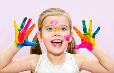 Wall Mural - Cute smiling little girl with hands in paint