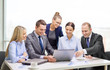 © Syda Productions - business team with laptop having discussion