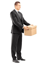 Canvas Print - Smiling businessman in suit giving a box to someone