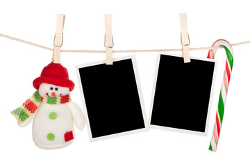 Blank photo frames and snowman hanging on the clothesline