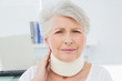 © lightwavemedia - Senior woman wearing cervical collar in medical office