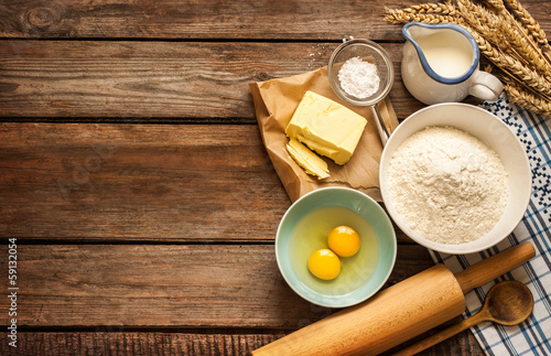 Fotografie, Obraz Dough recipe ingredients on vintage rural wood kitchen table