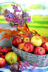 Poster - Juicy apples in basket on table on natural background