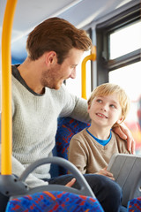 Wall Mural - Son Using Digital Tablet On Bus Journey With Father