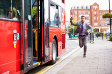 Businessman Running To Catch Bus Stop